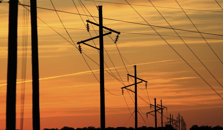 Intersecting transmission lines are pictured near Show Low, Ariz., Tuesday, April 22, 2025. (AP Photo/Susan Montoya Bryan)