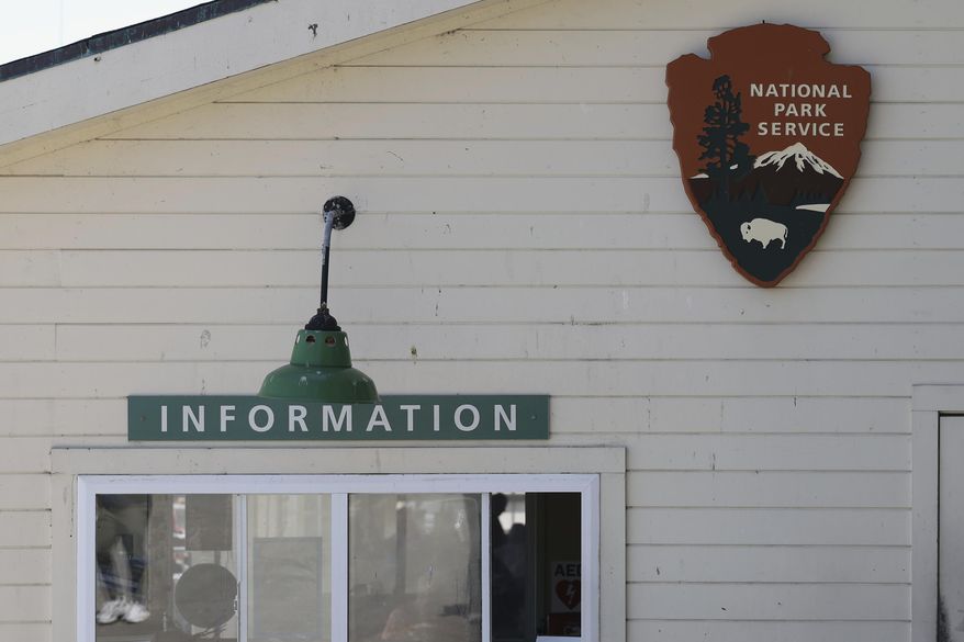 A National Park Service sign is shown above an Information booth during a tour of Alcatraz Island in San Francisco, Monday, May 5, 2025. (AP Photo/Jed Jacobsohn)