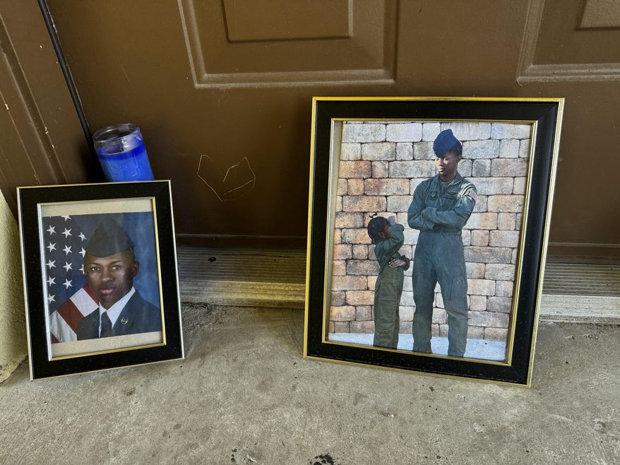 FILE - Candles and framed photos of Roger Fortson, a U.S. Air Force senior airman who was fatally shot by a Fla. sheriff's deputy on May 3, 2024, sit in the doorway of the apartment where he was killed in Fort Walton Beach, Fla., on Aug. 23. (AP Photo/Kate Payne, File)