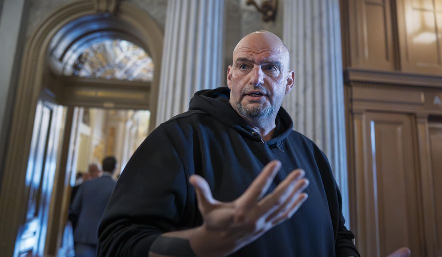 Sen. John Fetterman, D-Pa., talks to reporters outside the chamber during a vote at the Capitol in Washington, March 13, 2025. (AP Photo/J. Scott Applewhite) ** FILE **