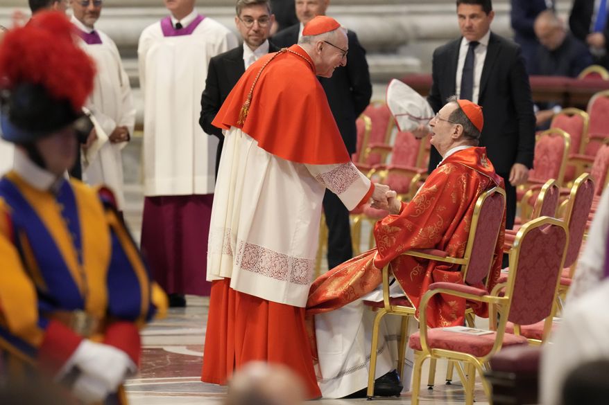Cardinal Pietro Parolin, center, greets Cardinal Giovanni Lajolo during a final Mass celebrated by cardinals inside St. Peter's Basilica, before the conclave to elect a new pope, at the Vatican, Wednesday, May 7, 2025. (AP Photo/Gregorio Borgia)