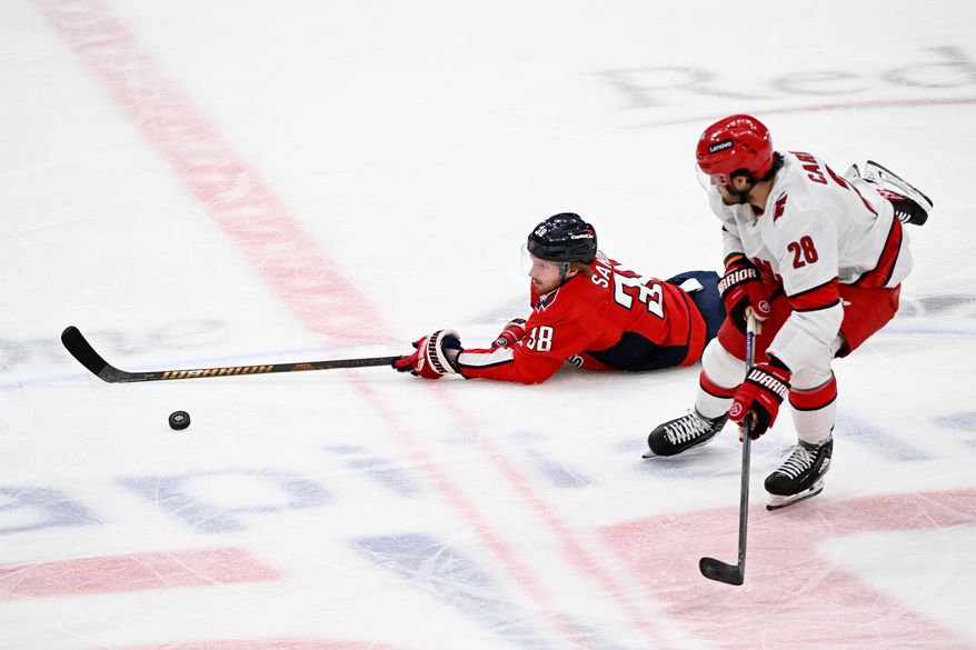 Washington Capitals defenseman Rasmus Sandin (38) reaching for the puck during the second period of an NHL playoff game against the Carolina Hurricanes at Capital One Arena in Washington D.C., May 8, 2025. (Photo for the Washington Times)