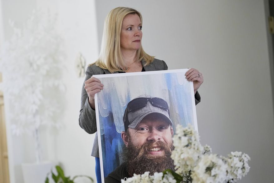 Stacey Wales, sister of the late Christopher Pelkey, displays her brother's image at her mother's home, Wednesday, May 7, 2025, in Chandler, Ariz. (AP Photo/Matt York)