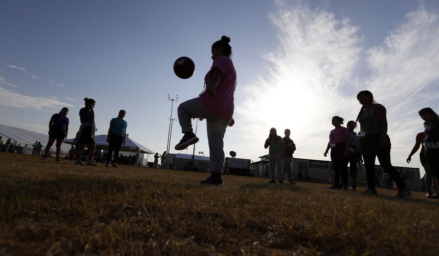 Immigrants play soccer at the U.S. government holding center for migrant children in Carrizo Springs, Texas, on July 9, 2019. (AP Photo/Eric Gay, File)