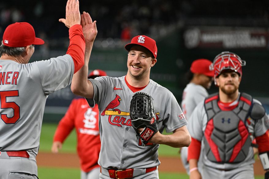 St. Louis Cardinals starting pitcher Erick Fedde (12) high-fiving third base coach Ron Warner after throwing a complete game, six-hit shutout over the Washington Nationals at Nationals Park in Washington D.C., May 9, 2025. (Photo by All-Pro Reels for Washington Times Sports)