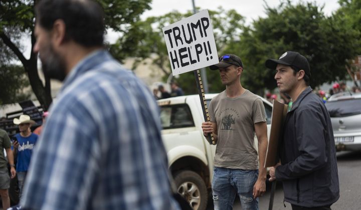 White South Africans demonstrate in support of U.S. President Donald Trump in front of the U.S. Embassy in Pretoria, South Africa, Saturday, Feb. 15, 2025. (AP Photo/Jerome Delay, File)