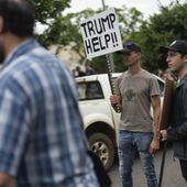 White South Africans demonstrate in support of U.S. President Donald Trump in front of the U.S. Embassy in Pretoria, South Africa, Saturday, Feb. 15, 2025. (AP Photo/Jerome Delay, File)