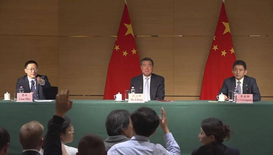 Vice minister of Finance Liao Min, left, gestures toward a journalist at a news conference at the Chinese mission to the World Trade Organization in Geneva, Switzerland, Sunday, May 11, 2025, alongside Vice Premier He Lifeng and Li Chenggang, vice minister of commerce. (AP Photo/Jamey Keaten)