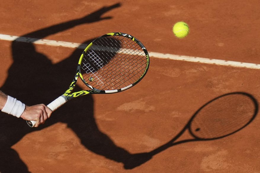 Netherlands' Jesper De Jong casts his shadow on the court as he returns the ball to Italy's Jannik Sinner during their tennis match at the Italian Open at the Foro Italico, in Rome, Monday, May 12, 2025. (AP Photo/Alessandra Tarantino)