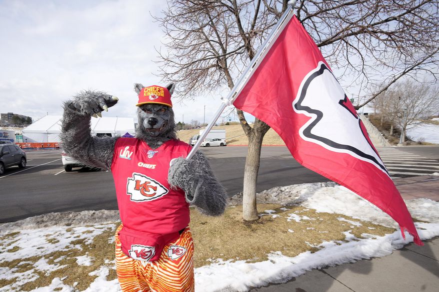 FILE - A Kansas City Chiefs fan, ChiefsAholic, poses for photos while walking toward Empower Field at Mile High before an NFL football game between the Denver Broncos and the Chiefs, Jan. 8, 2022, in Denver. (AP Photo/David Zalubowski, File)
