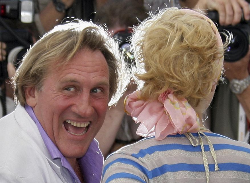 French actor Gerard Depardieu, left, and Belgian actress Cecile de France pose during a photo call for the film "Quand J'etais Chanteur," at the 59th International film festival in Cannes, southern France, on May 26, 2006. (AP Photo/Francois Mori, File)