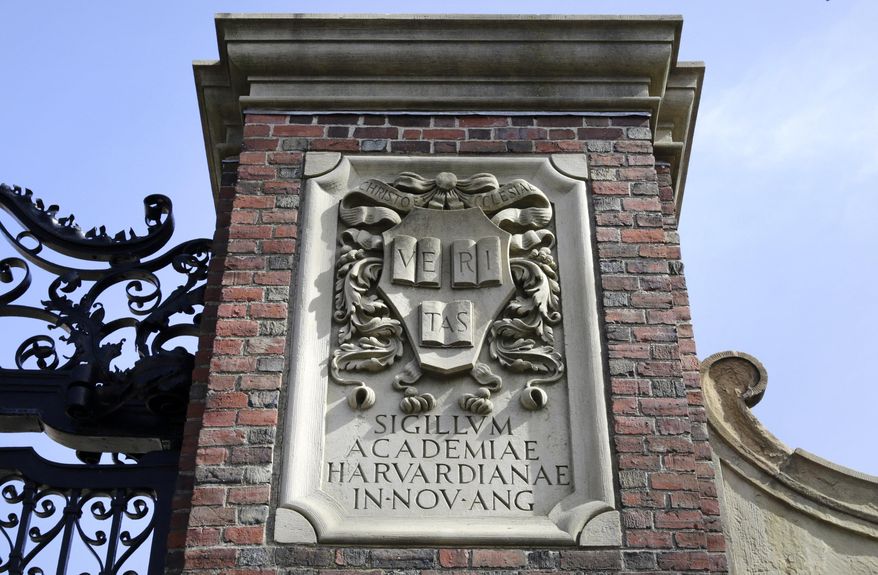 A relief sculpture rests on a gate to the entrance of Harvard University, in Cambridge, Mass., March 13, 2016. (AP Photo/Steven Senne, File)