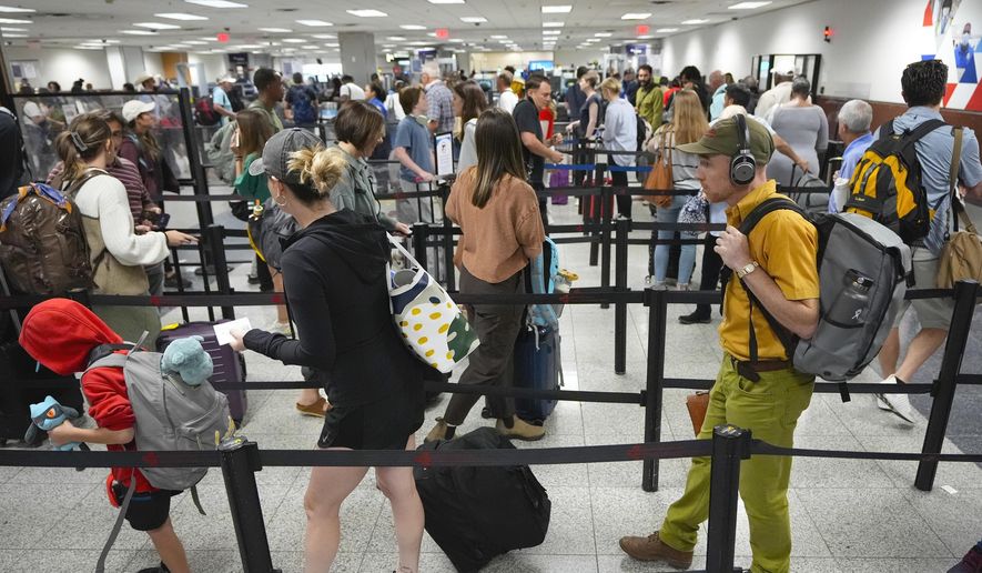 Travelers line up for security clearance at Hartsfield-Jackson Atlanta International Airport, June 28, 2024, in Atlanta. (AP Photo/Pablo Martinez Monsivais, File)