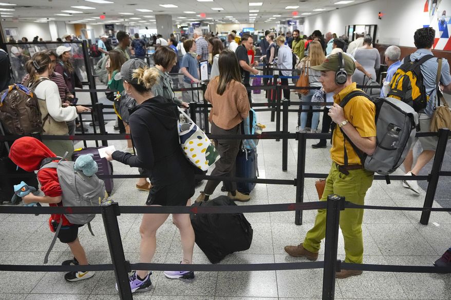Travelers line up for security clearance at Hartsfield-Jackson Atlanta International Airport, June 28, 2024, in Atlanta. (AP Photo/Pablo Martinez Monsivais, File)