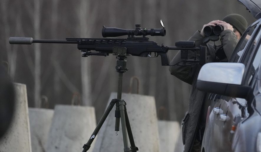 FILE - A Polish soldier at Poland's border with Russia, in Dabrowka, Poland, on Saturday Nov. 30, 2024. (AP Photo/Czarek Sokolowski, File)