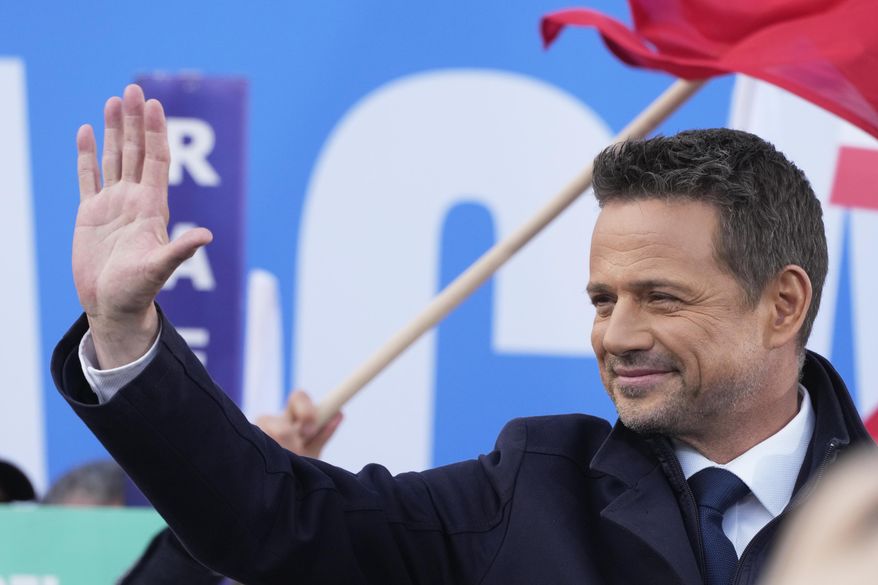 Warsaw Mayor Rafał Trzaskowski, a liberal candidate in Poland's presidential election, waves to supporters during a campaign stop, in Lodz, Poland, Friday, May 9, 2025. (AP Photo/Czarek Sokolowski)