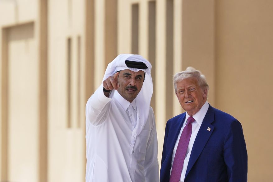 Qatar's Emir Sheikh Tamim bin Hamad Al Thani gestures next to President Donald Trump at Al Udeid Air Base, Thursday, May 15, 2025, in Doha, Qatar. (AP Photo/Alex Brandon)