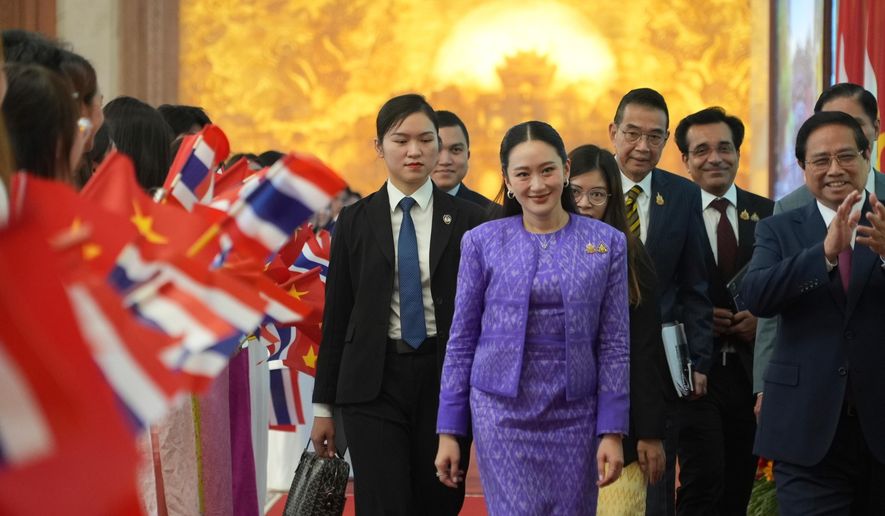 Thai Prime Minister Paetongtarn Shinawatra, front center, walks to a meeting in Hanoi, Vietnam Friday, May 16, 2025. (AP Photo/Hau Dinh)