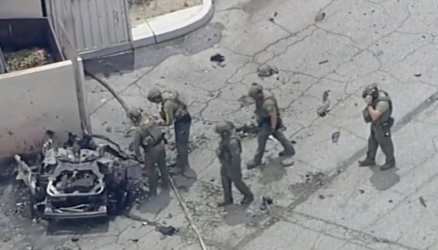 Law enforcement officers investigate a vehicle after an explosion on Saturday, May 17, 2025, in Palm Springs, Calif. (ABC7 Los Angeles via AP) ** FILE **