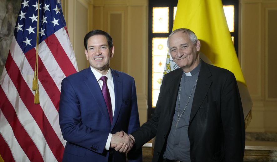 Secretary of State Marco Rubio, left, and President of the Conference of Italian Bishops, Cardinal Matteo Zuppi, pose for a photo at the U.S. Embassy to the Holy See in Rome, Saturday, May 17, 2025. (AP Photo/Gregorio Borgia)