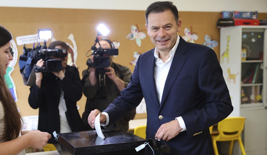 Incumbent Prime Minister and leader of the center-right Social Democratic Party Luis Montenegro casts his ballot in Portugal's general election at polling station in Espinho, Portugal, Sunday, May 18, 2025. (AP Photo/Luis Vieira)