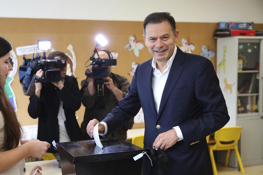 Incumbent Prime Minister and leader of the center-right Social Democratic Party Luis Montenegro casts his ballot in Portugal's general election at polling station in Espinho, Portugal, Sunday, May 18, 2025. (AP Photo/Luis Vieira)