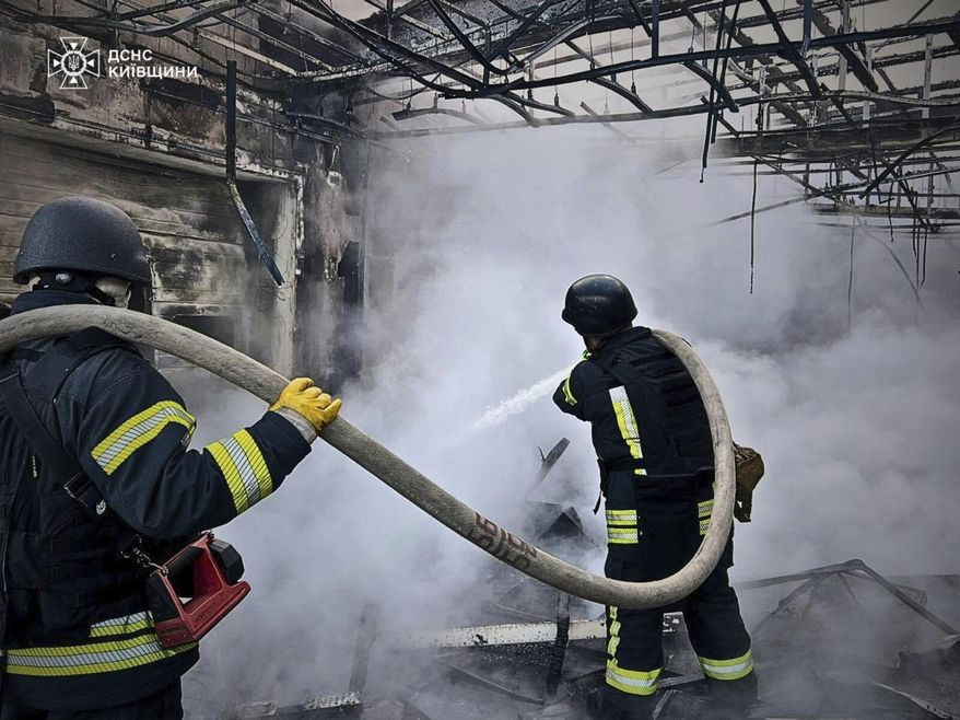 In this photo provided by the Ukrainian Emergency Service, firefighters put out the fire following Russia's drone attack in the Kyiv region, Ukraine, Sunday, May 18, 2025. (Ukrainian Emergency Service via AP)