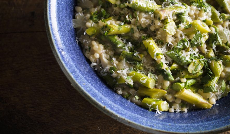 This image released by Milk Street shows a recipe for pearl couscous “risotto” with asparagus. (Milk Street via AP)