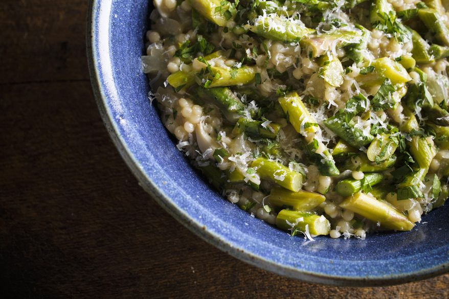 This image released by Milk Street shows a recipe for pearl couscous “risotto” with asparagus. (Milk Street via AP)