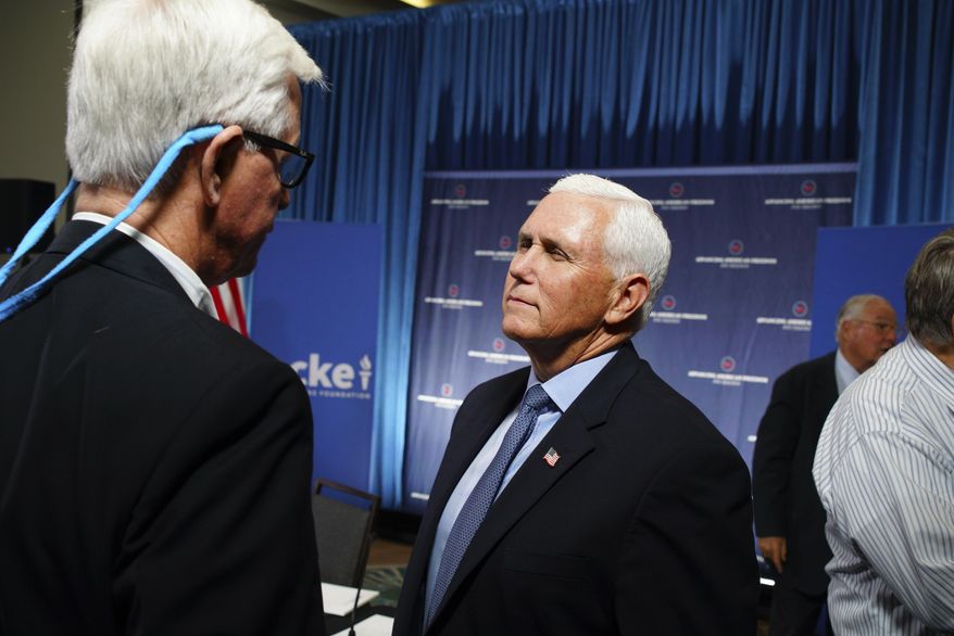 Former Vice President Mike Pence, right, speaks with businessman H.O. Woltz III following a panel discussion on tariffs in Raleigh, N.C., on Monday, May 19, 2025. (AP Photo/Allen G. Breed)