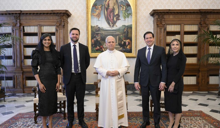 Pope Leo XIV stands for a family photo with Vice President JD Vance, second from left, his wife Usha Vance, Secretary of State Marco Rubio, second from right, and his wife Jeanette Dousdebes Rubio, on the occasion of their meeting at the Vatican, Monday, May 19, 2025. (Vatican Media via AP)