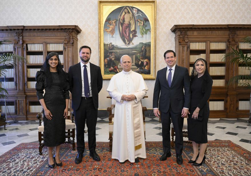 Pope Leo XIV stands for a family photo with Vice President JD Vance, second from left, his wife Usha Vance, Secretary of State Marco Rubio, second from right, and his wife Jeanette Dousdebes Rubio, on the occasion of their meeting at the Vatican, Monday, May 19, 2025. (Vatican Media via AP)