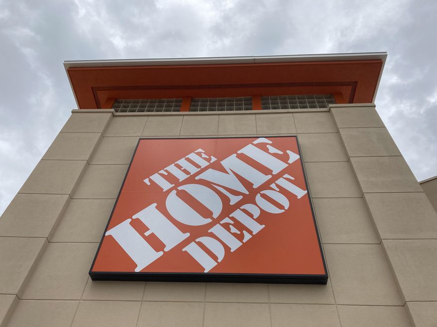 A Home Depot logo sign hangs on its facade, Friday, May 14, 2021, in North Miami, Fla. (AP Photo/Wilfredo Lee, File)