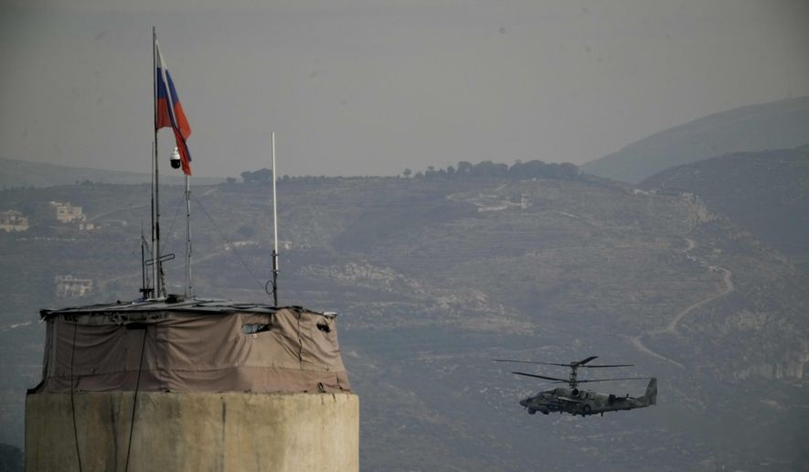 A Russian helicopter flies over the Hmeimim Air Base, a Syrian airbase currently operated by Russia, located southeast of the city of Latakia in the town of Hmeimim, Syria, on Monday, Dec.16, 2024. (AP Photo/Leo Correa, File)