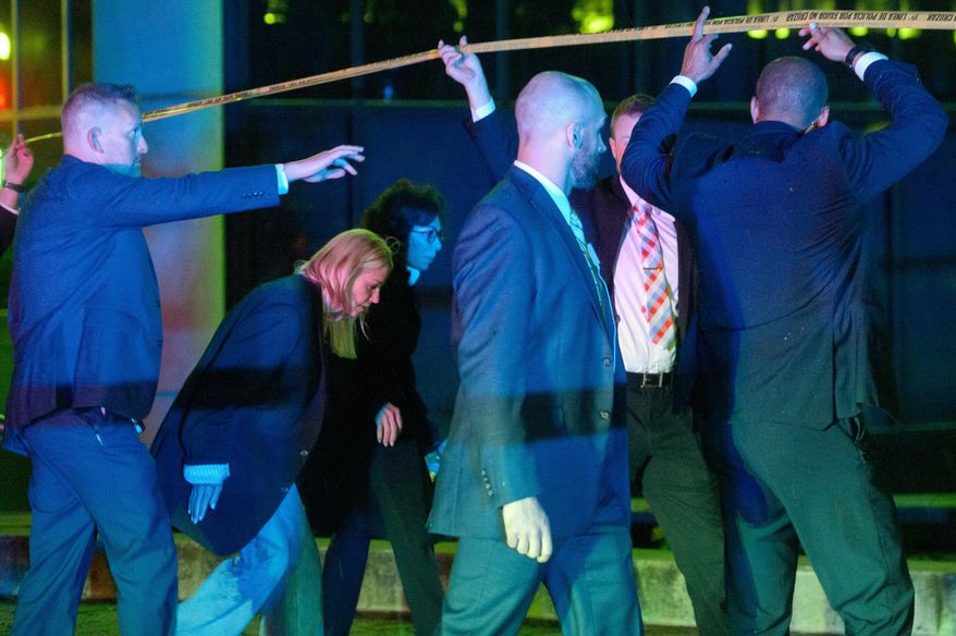 Attorney General Pam Bondi, from second left, and U.S. Attorney for the District of Columbia Jeanine Pirro walk to cars as law enforcement work the scene after two staff members of the Israeli Embassy in Washington were shot and killed outside the Capital Jewish Museum, Thursday, May 22, 2025, in Washington. (AP Photo/Rod Lamkey, Jr.)