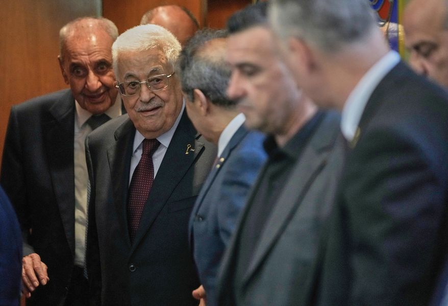Palestinian President Mahmoud Abbas, centre, leaves after his meeting with Lebanese Parliament Speaker Nabih Berri, left background, in Beirut, Lebanon, Thursday, May 22, 2025. (AP Photo/Hussein Malla)