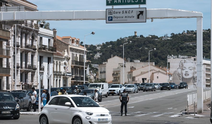 FILE - Police direct traffic during an electricity outage in Cannes, southern France, Saturday, May 24, 2025. (Photo by Lewis Joly/Invision/AP, File)