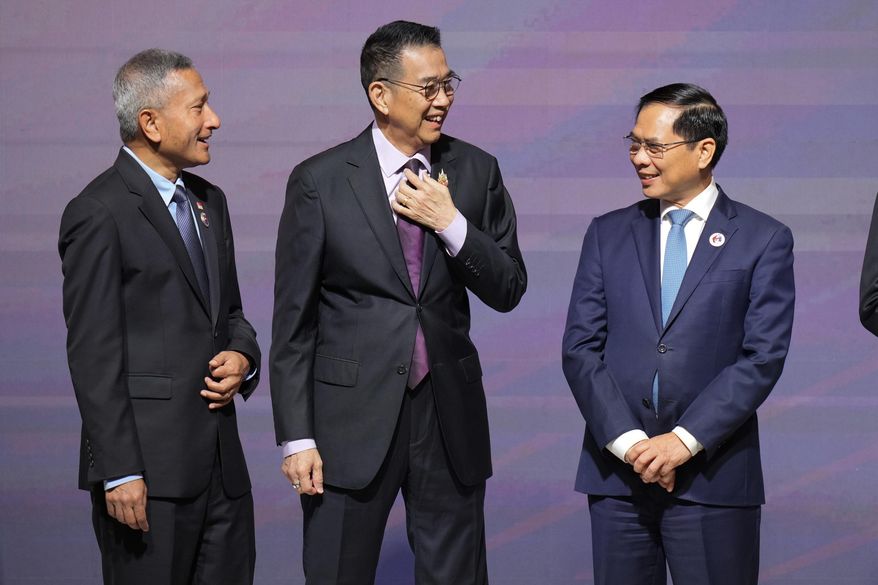 Singaporean Foreign Minister Vivian Balakrishnan, left, Thailand's Foreign Minister Maris Sangiampongsa, and Vietnam's Foreign Minister Bui Thanh Son, talk before a group photo at the Association of Southeast Asian Nations (ASEAN) Foreign Ministers' Meeting opening ceremony in Kuala Lumpur, Malaysia, Sunday, May 25, 2025.(AP Photo/Vincent Thian)