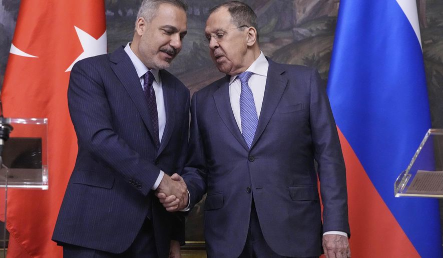 Russian Foreign Minister Sergey Lavrov, right, and Turkish Foreign Minister Hakan Fidan shake hands during their meeting in Moscow, Russia, Tuesday, May 27, 2025. (AP Photo/Pavel Bednyakov, Pool)