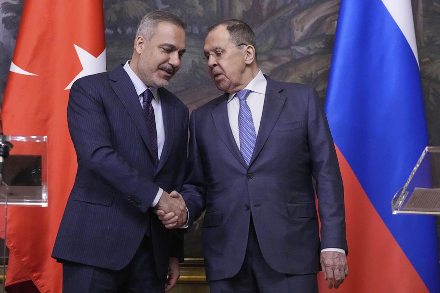 Russian Foreign Minister Sergey Lavrov, right, and Turkish Foreign Minister Hakan Fidan shake hands during their meeting in Moscow, Russia, Tuesday, May 27, 2025. (AP Photo/Pavel Bednyakov, Pool)