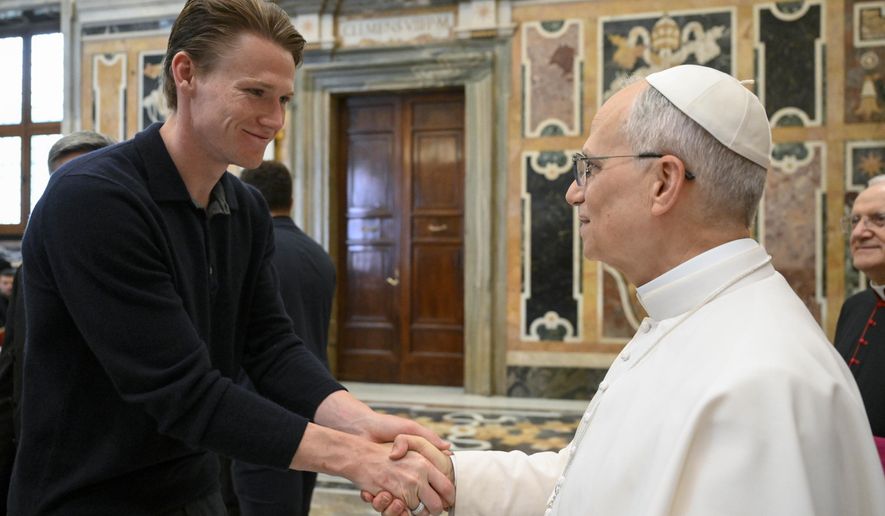 Napoli soccer team's midfielder Scott McTominay, left, shakes hands with Pope Leo XIV during a papal private audience with the team in the Clementine Hall at the Vatican, Tuesday, May 27, 2025. (Vadican Media via AP)