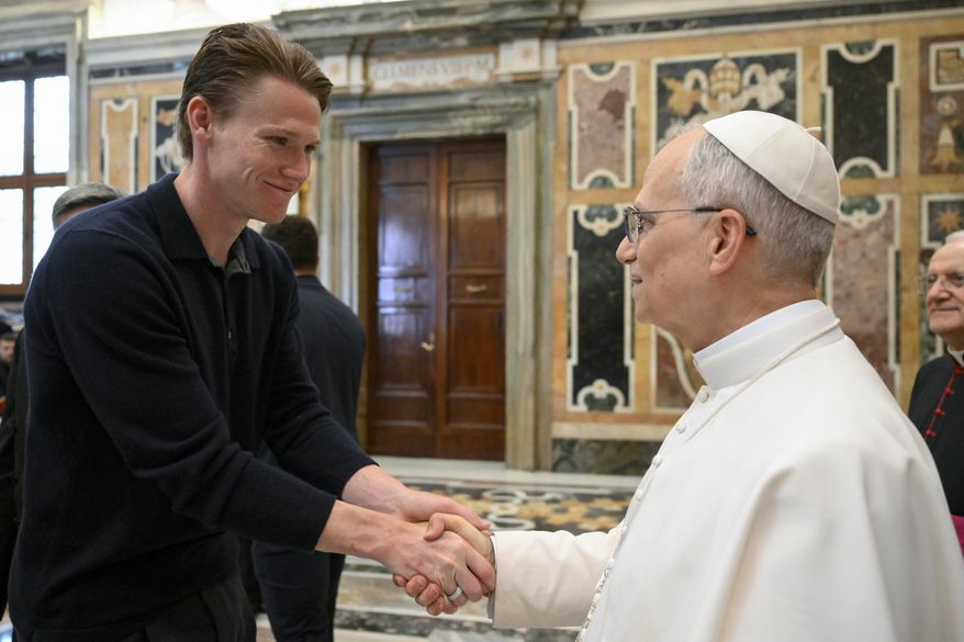 Napoli soccer team's midfielder Scott McTominay, left, shakes hands with Pope Leo XIV during a papal private audience with the team in the Clementine Hall at the Vatican, Tuesday, May 27, 2025. (Vadican Media via AP)