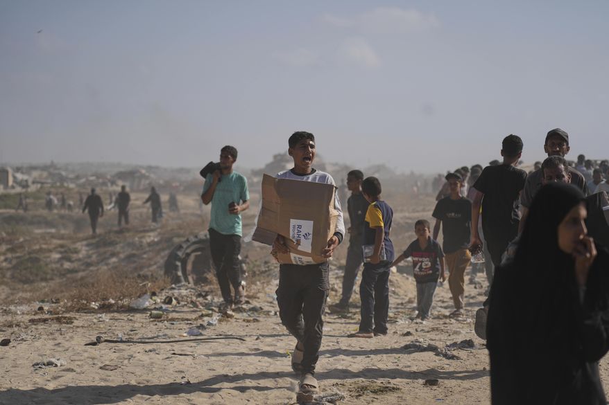 Palestinians carry boxes containing food and humanitarian aid packages delivered by the Gaza Humanitarian Foundation, a U.S.-backed organization approved by Israel, in Rafah, southern Gaza Strip, on Tuesday, May 27, 2025. (AP Photo/Abdel Kareem Hana)
