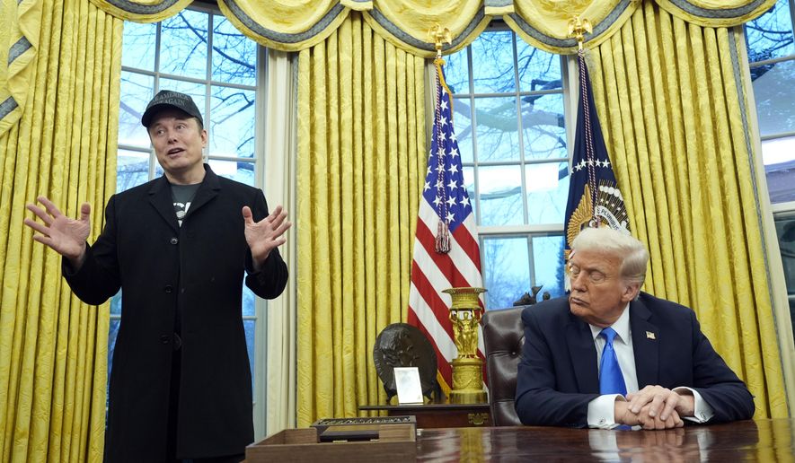 President Donald Trump listens as Elon Musk speaks in the Oval Office at the White House, Feb. 11, 2025, in Washington. (AP Photo/Alex Brandon, File)
