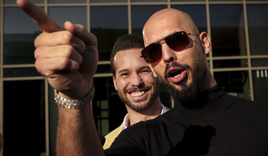 Andrew Tate gestures, next to his brother Tristan, outside the Bucharest Tribunal in Bucharest, Romania, Thursday, Jan. 9, 2025. (AP Photo/Vadim Ghirda, File)