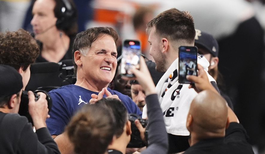 Mark Cuban, center left, greets former Dallas Mavericks player Luka Doncic of the Los Angeles Lakers following an NBA basketball game in Dallas, April 9, 2025. (AP Photo/LM Otero, file)