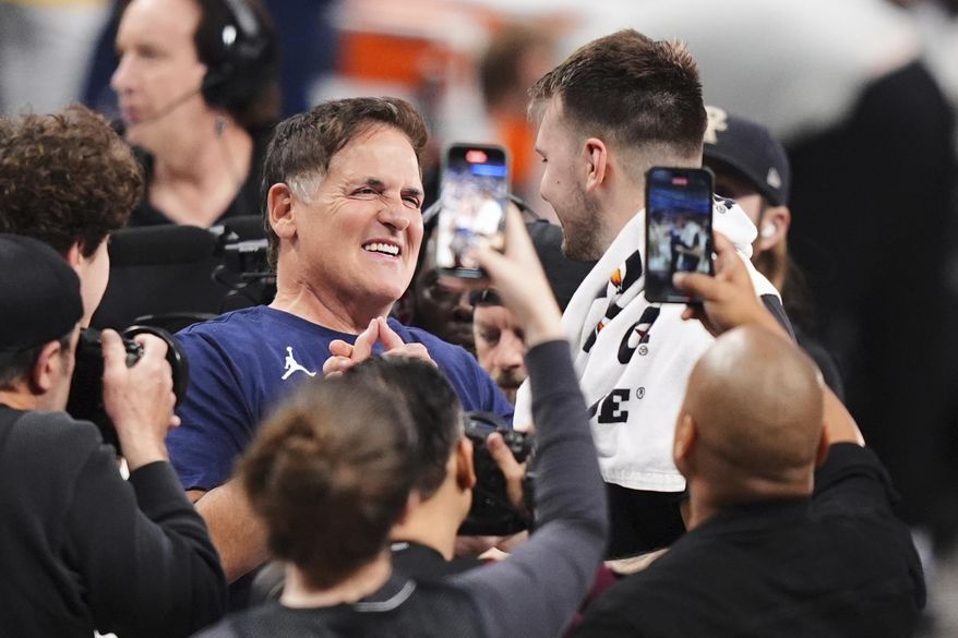 Mark Cuban, center left, greets former Dallas Mavericks player Luka Doncic of the Los Angeles Lakers following an NBA basketball game in Dallas, April 9, 2025. (AP Photo/LM Otero, file)
