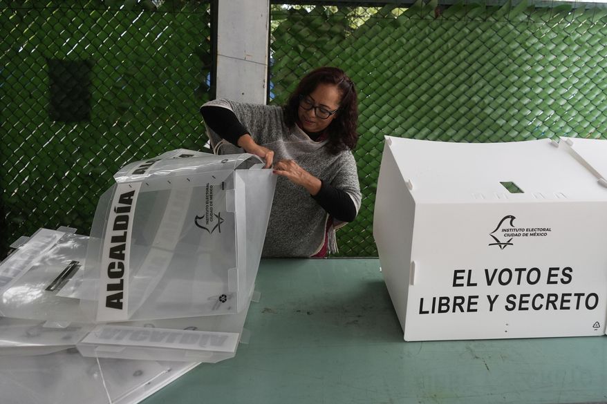 An electoral worker prepares ballot boxes for the country's first judicial elections in Mexico City, June 1, 2025. (AP Photo/Fernando Llano)