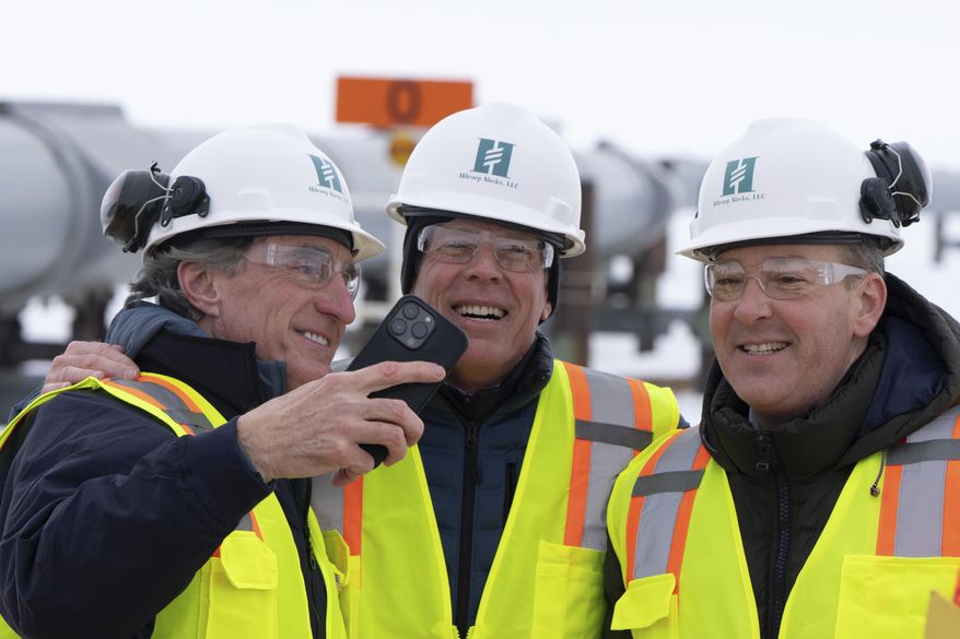 From left, Interior Secretary Doug Burgum, Energy Secretary Chris Wright and EPA Administrator Lee Zeldin smile after posing for a photo with the Trans-Alaska Pipeline in the background after a news conference at the Pump Station 1 on Monday, June 2, 2025, located near Deadhorse, Alaska, on the state's prodigious North Slope. (AP Photo/Jenny Kane)