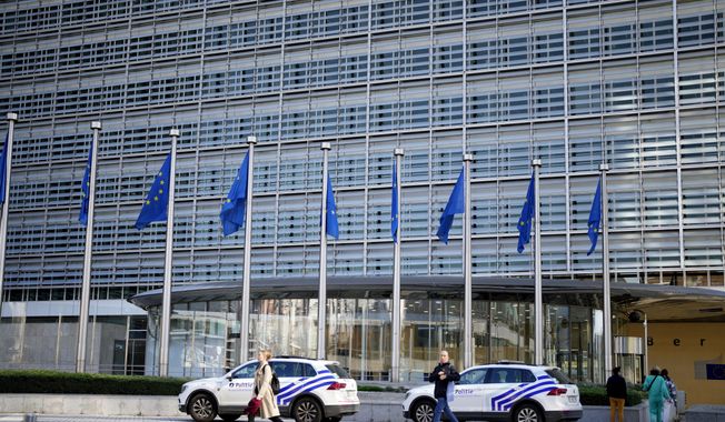 FILE - Police cars stand outside EU headquarters in Brussels, Sept. 30, 2022. (AP Photo/Virginia Mayo, file)